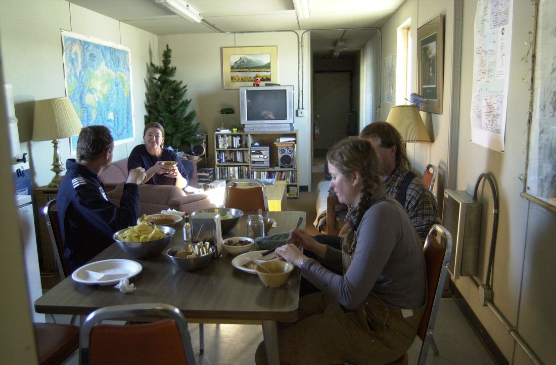 A helicopter crew eating lunch at a table at Marble Point camp, Antarctica