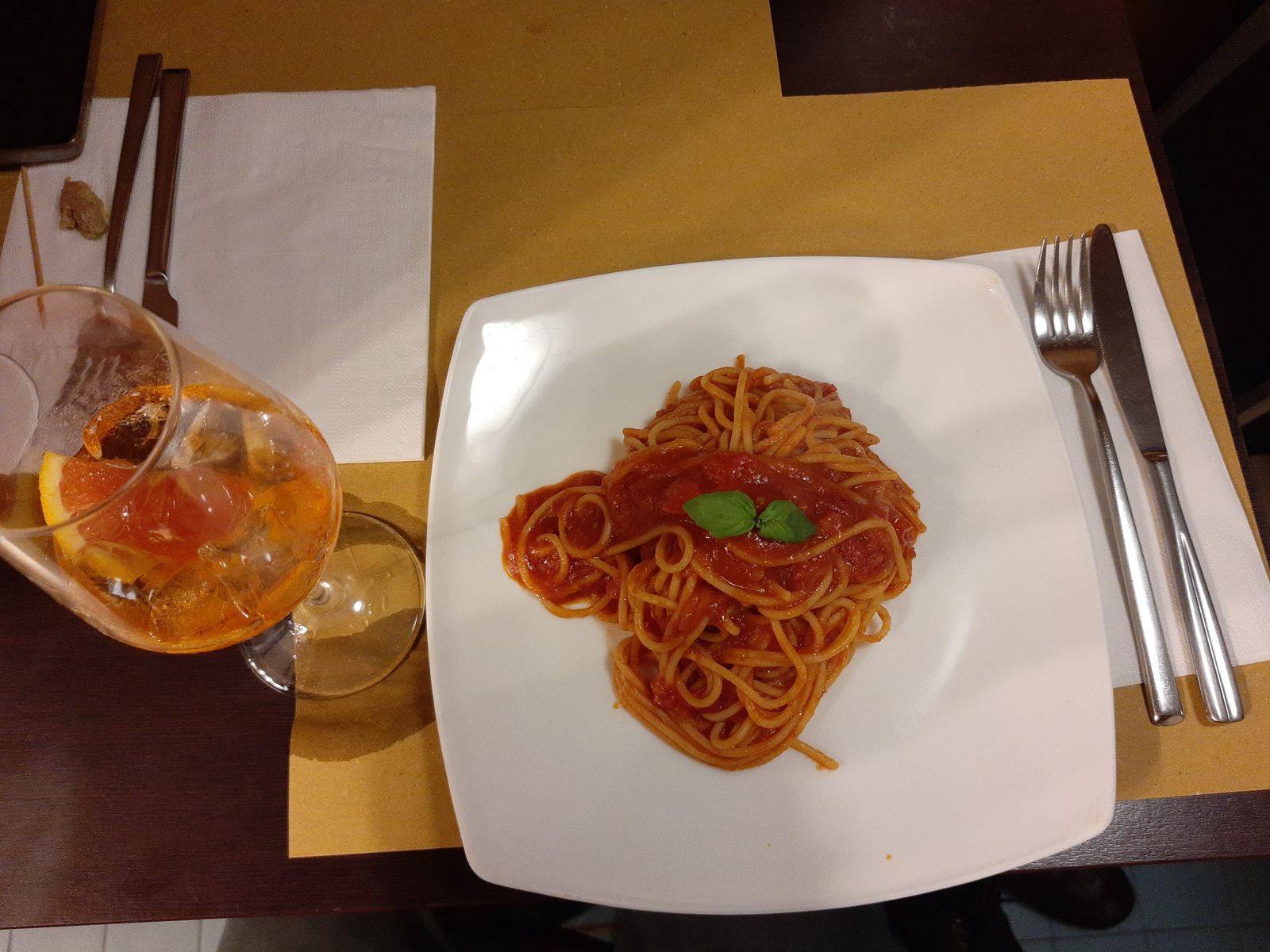 A plate of spaghetti in red tomato sauce with basil in a Venice restaurant
